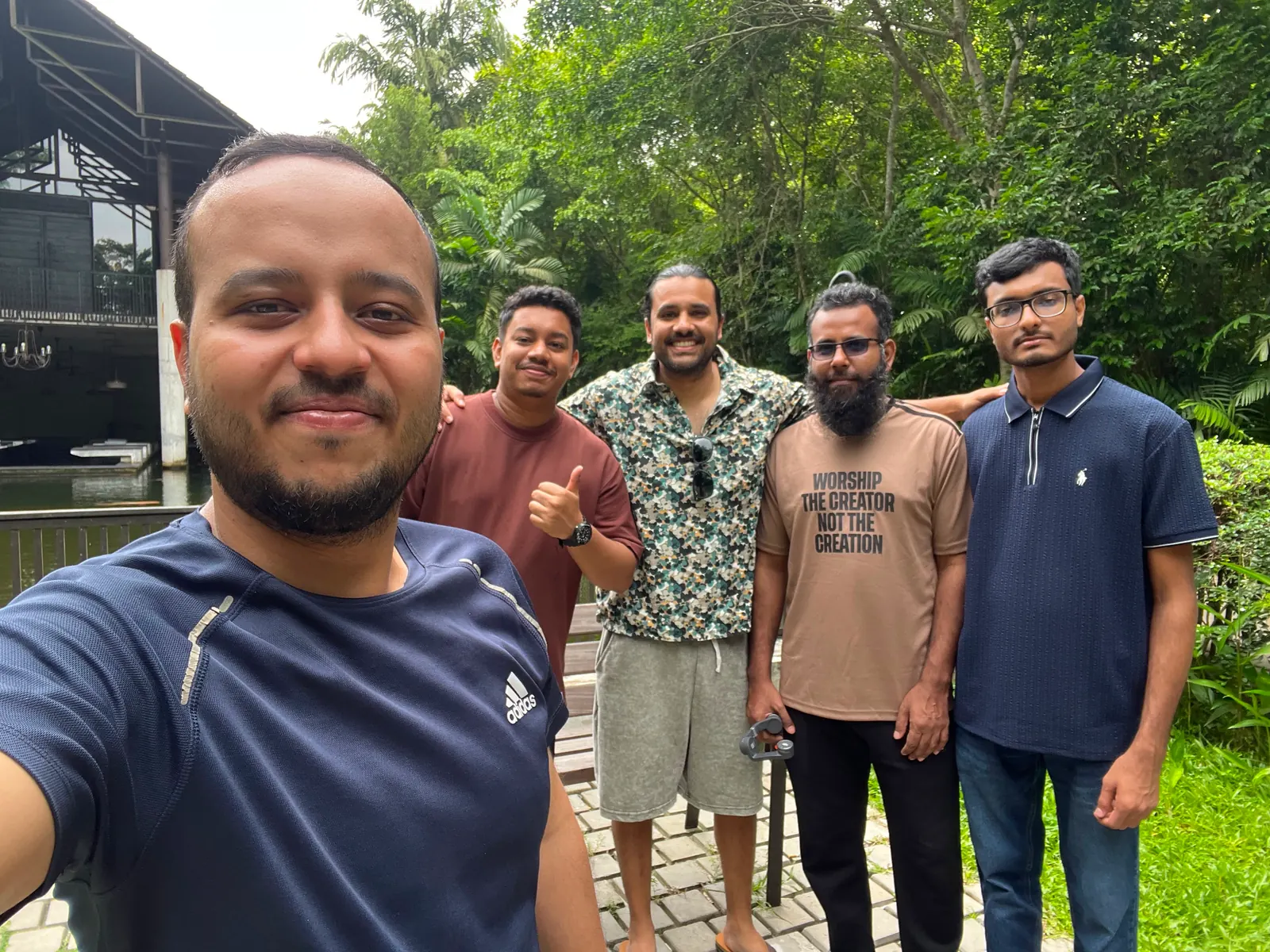Group selfie with the Mangosteen Studio team by the koi-pond lodge, Bhawal