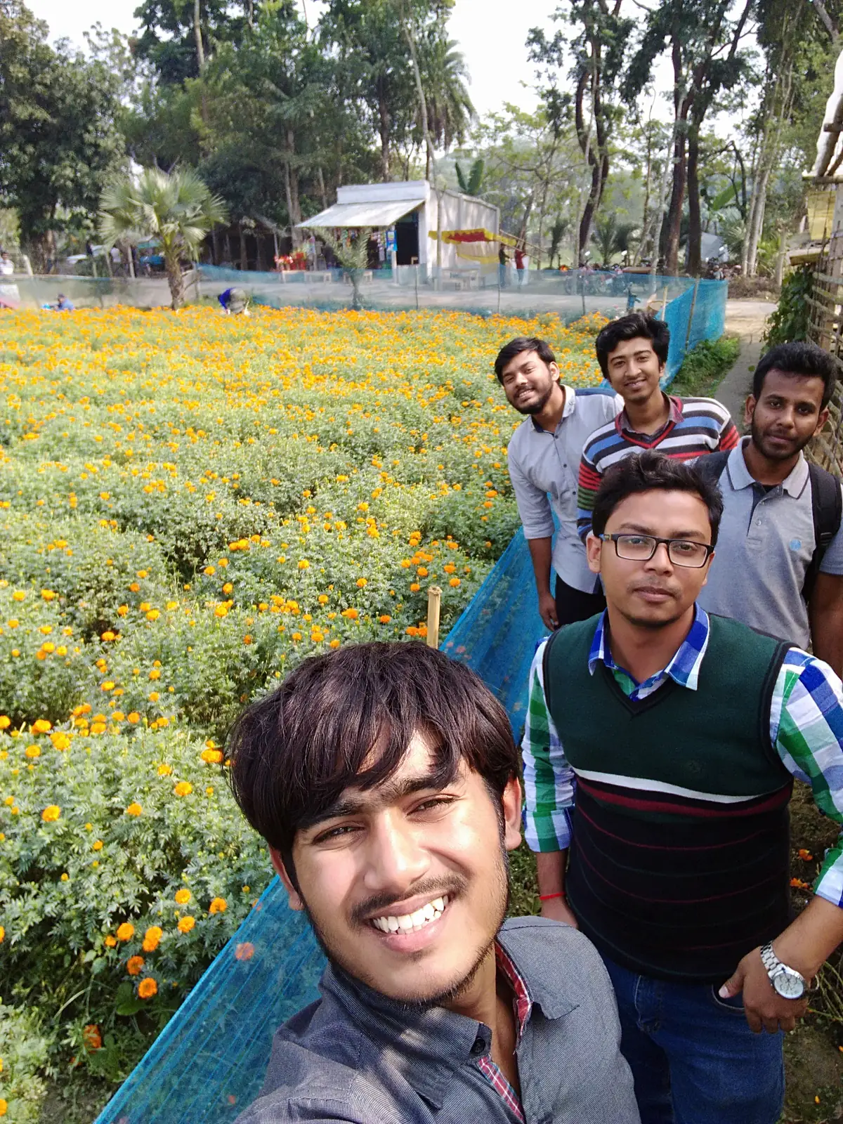 Selfie with friends beside a blooming marigold field