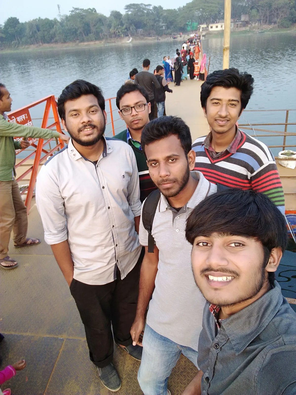Golden-hour selfie with friends on the floating footbridge