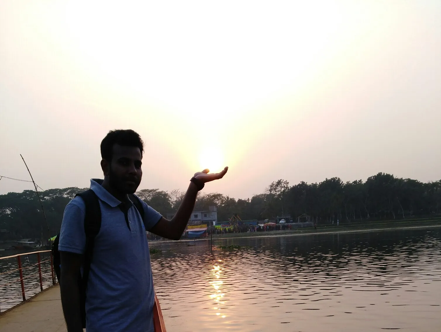 Holding the setting sun in an open palm beside the lake