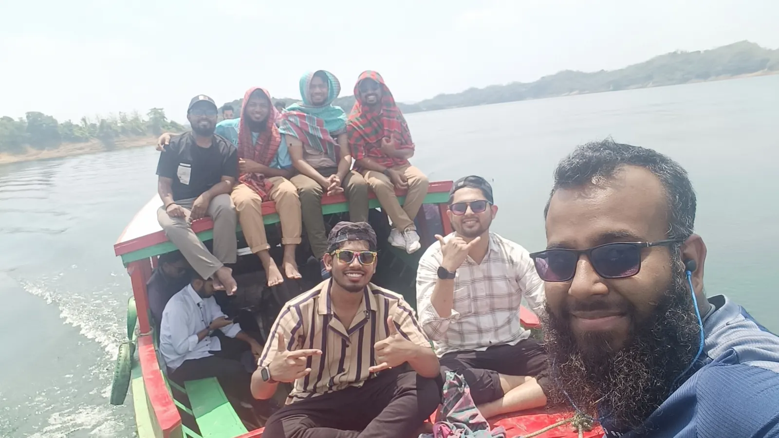 The whole group riding the bow of the engine boat across the lake