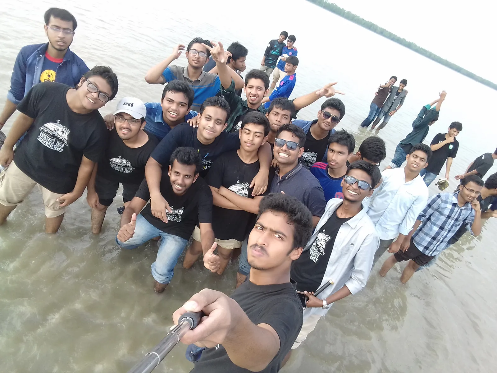 Group selfie wading in the river on the Kuakata tour