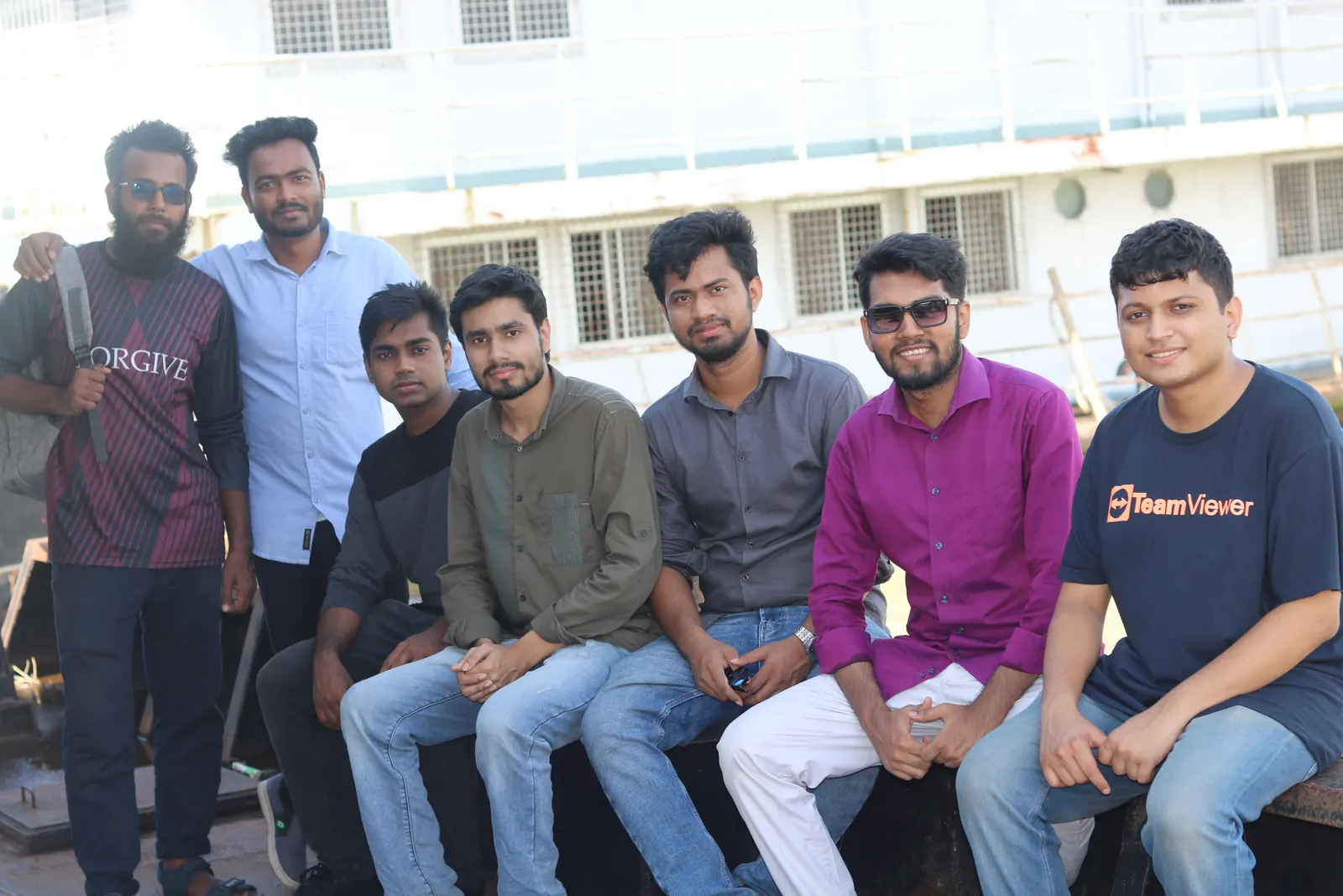 The whole group in front of a white river launch at the ghat