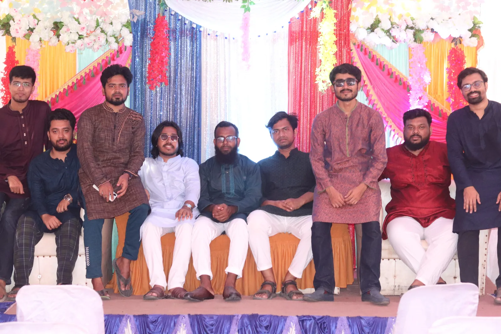 Friends posed on the flower-decorated wedding stage