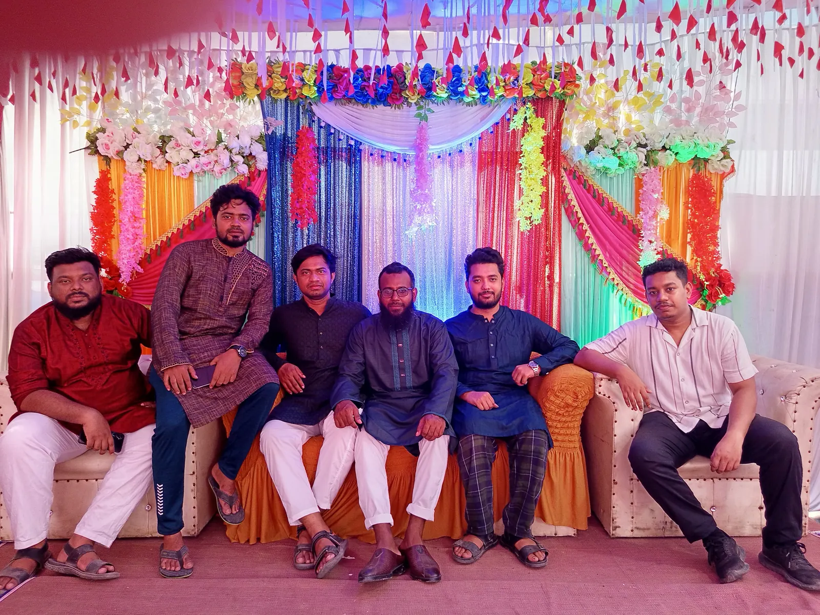With friends in front of the vibrant wedding stage backdrop