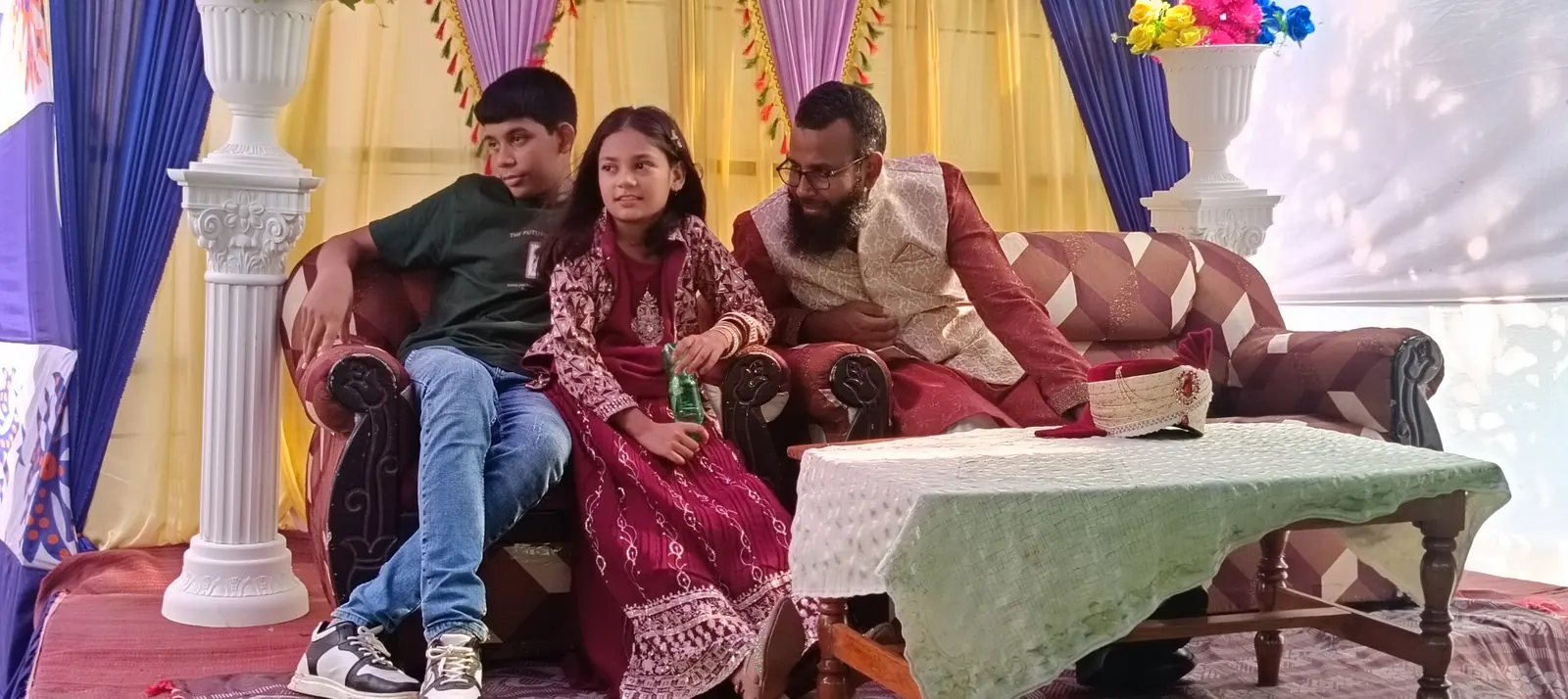 Sitting with two of the children on the wedding stage