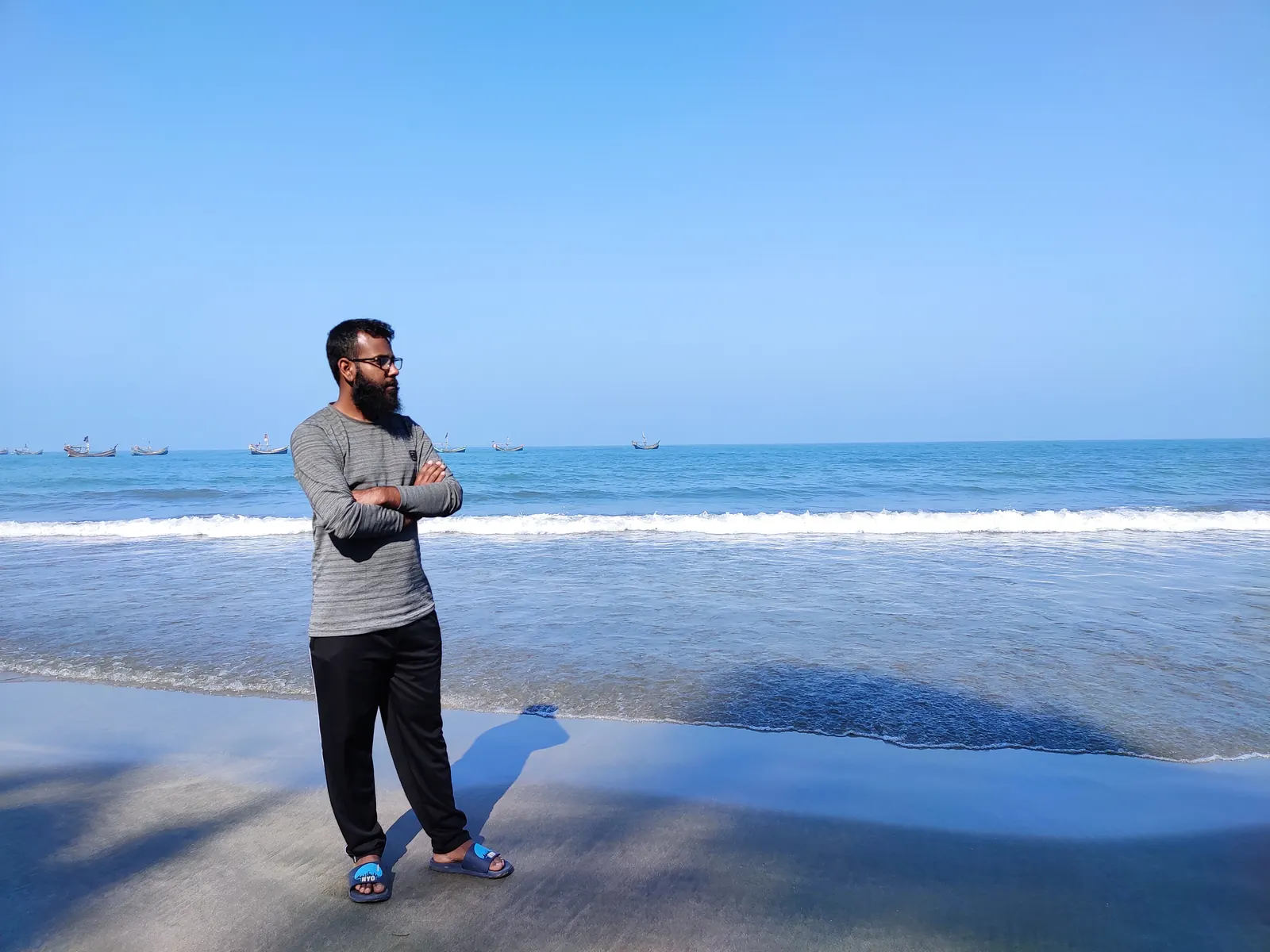 Standing at the waterline with the surf running in behind
