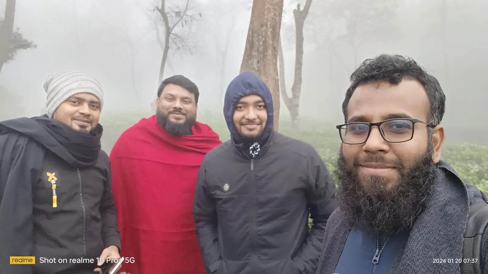 Four of us bundled up in the tea garden at dawn, fog in the trees