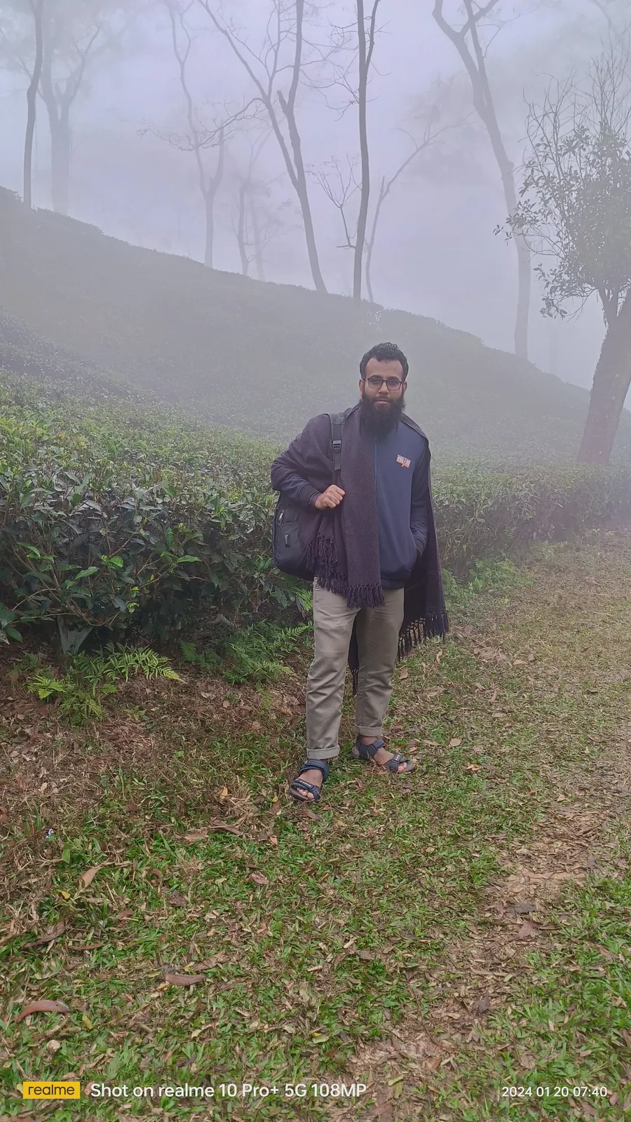 Walking a path between the tea rows on a hillside in the mist
