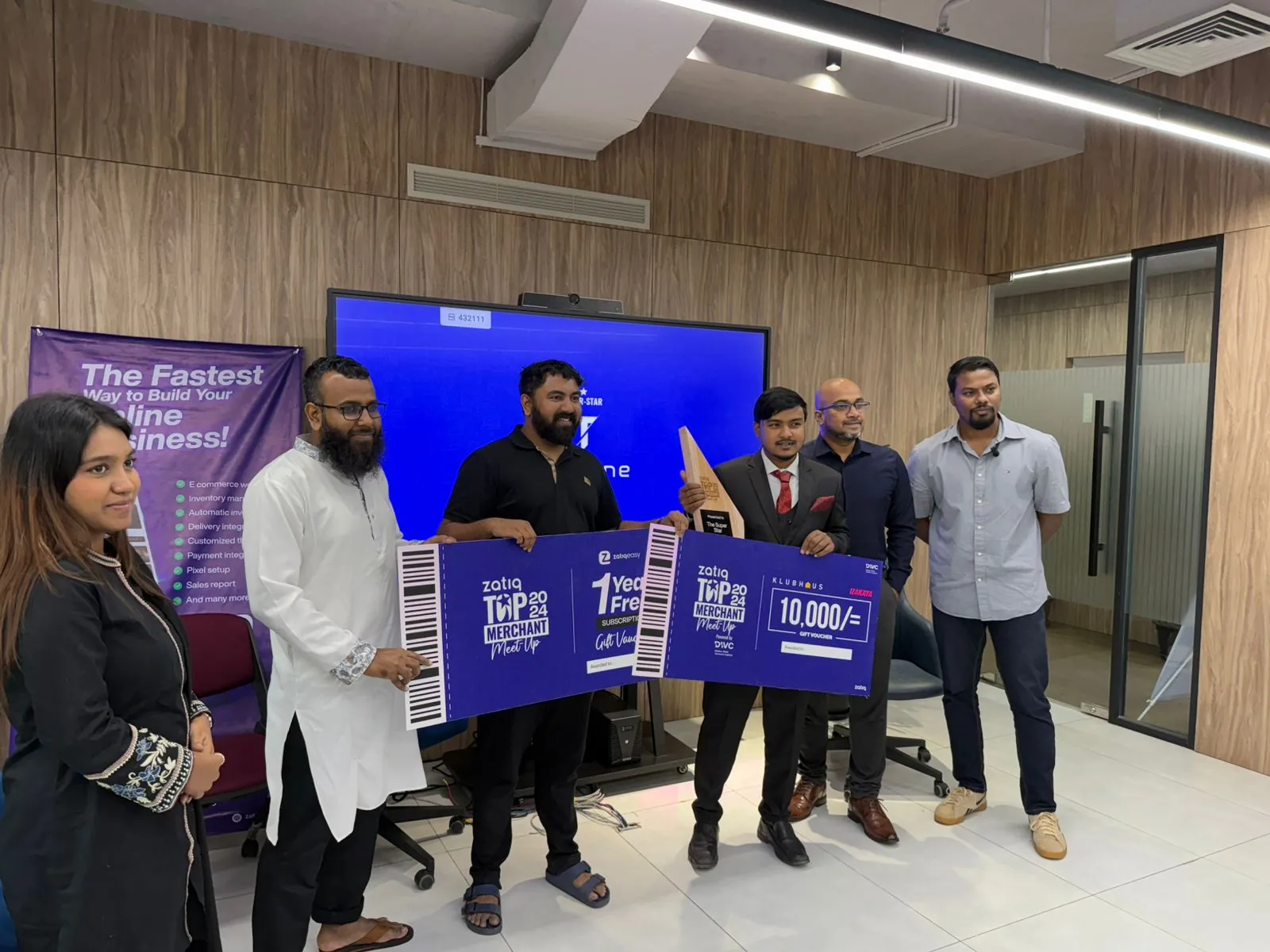 The Zatiq team posing with the Top Merchant 2024 meet-up sign