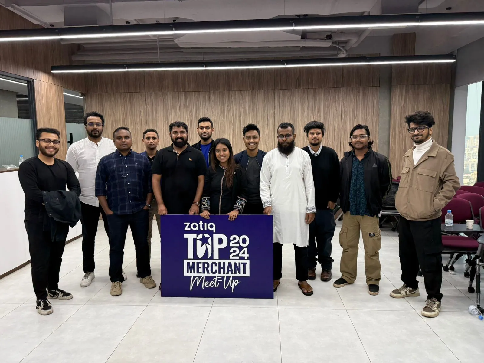 Team photo with the Top Merchant 2024 sign